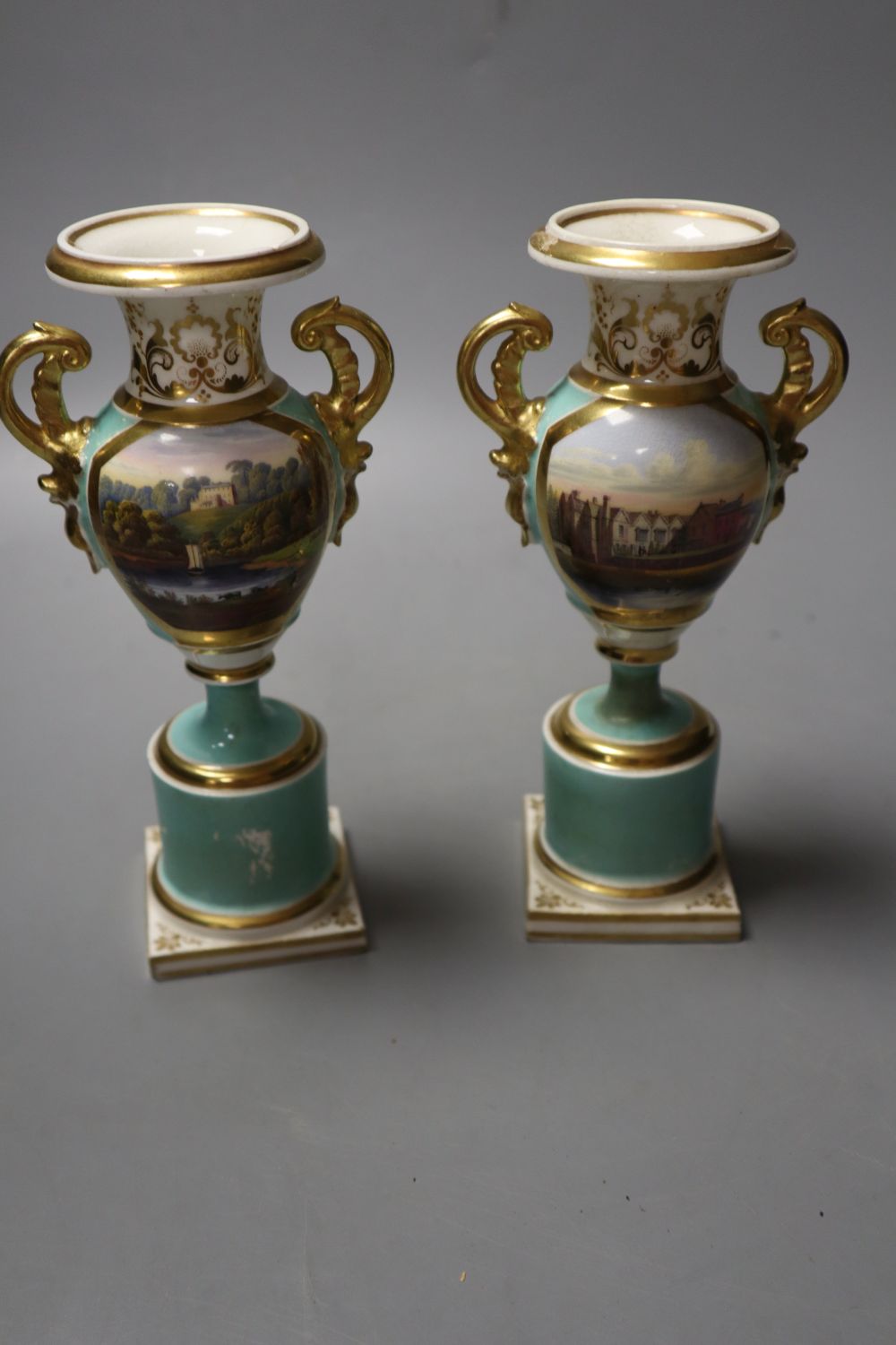 A pair of Grainger Worcester two handled vases painted with named landscapes on a sea-green ground, 17.5cm